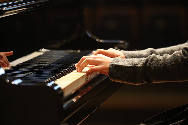 istock Woman playing the piano 2250443769