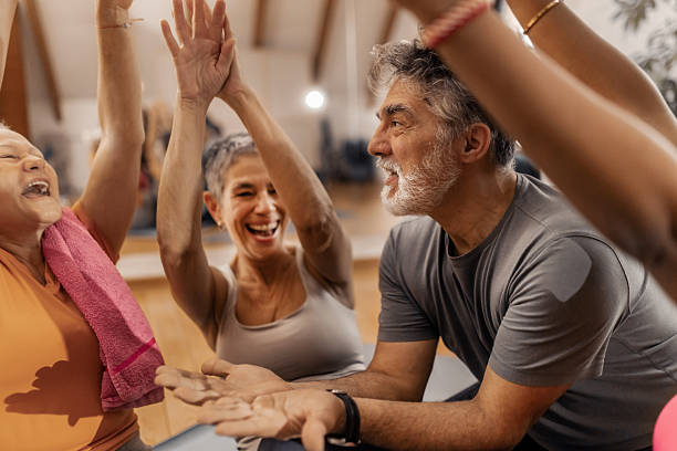 istock Older adults enjoying a friendly post workout conversation with their fitnes coach 2250447765