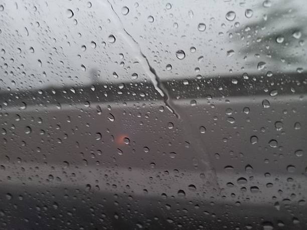 istock Raindrops clinging to a windowpane blurring the outside world creating a moody atmosphere 2250449755