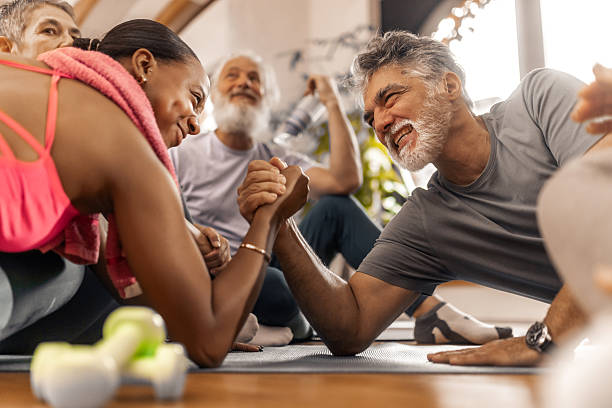 istock Funny strenght challenge between trainer and senior during a workout 2250450556
