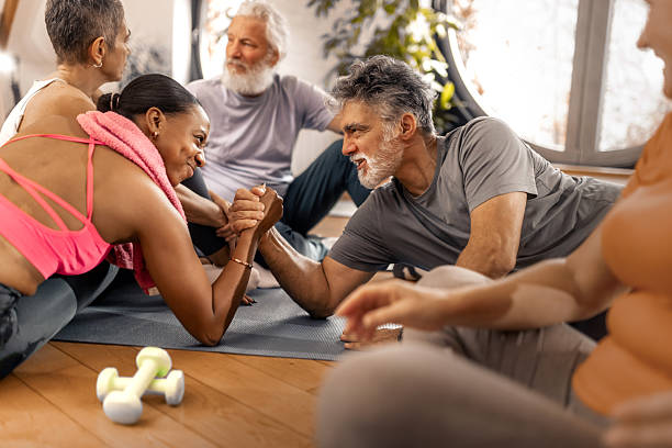 istock Funny strenght challenge between trainer and senior during a workout 2250450557