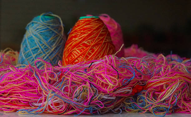 istock Woolen threads of different colors stand in rows 2250457000