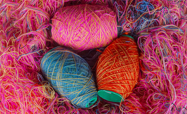 istock Woolen threads of different colors stand in rows 2250457001