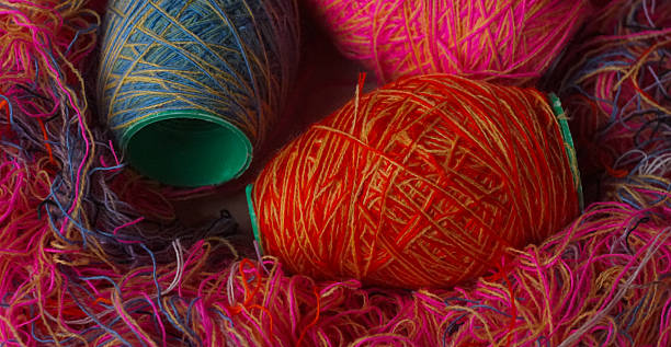 istock Woolen threads of different colors stand in rows 2250457011