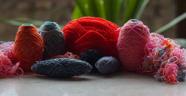 istock Woolen threads of different colors stand in rows 2250457047
