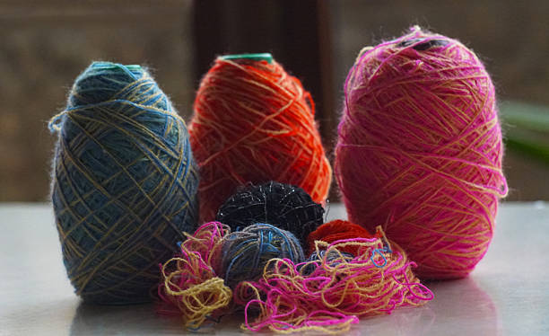 istock Woolen threads of different colors stand in rows 2250457090
