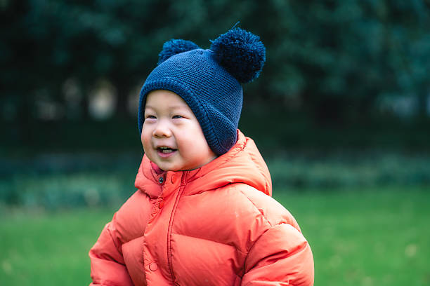 Portrait of a 1-years-old Chinese little boy in a park in winter