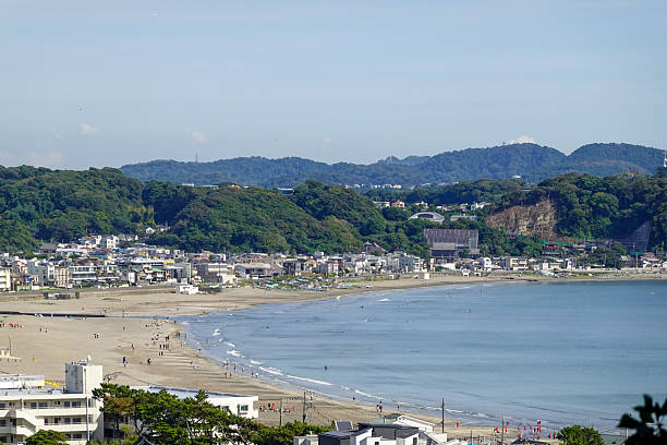 istock Wide sandy Japanese beach with gentle coastal waves 2250458584