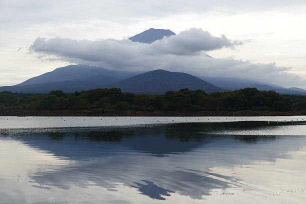 Mount Fuji reflected in a calm lake, creating a nearly perfect mirror image.