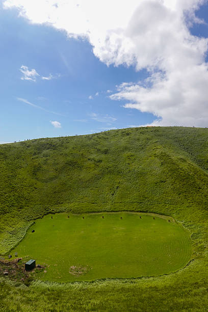 istock Circular grassy crater on sunny mountaintop plateau 2250459951