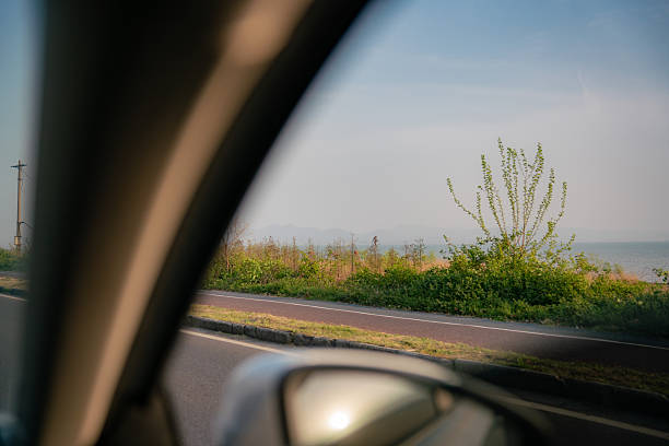 istock View from car window showing roadside vegetation and sea 2250460011