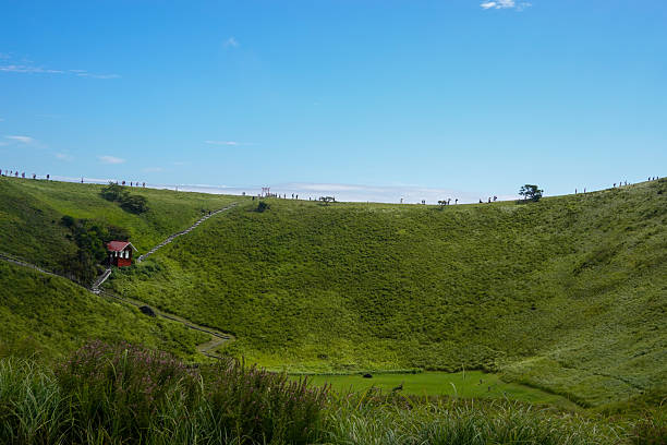 istock Bright green hillside sloping gently toward distant blue sea 2250460209