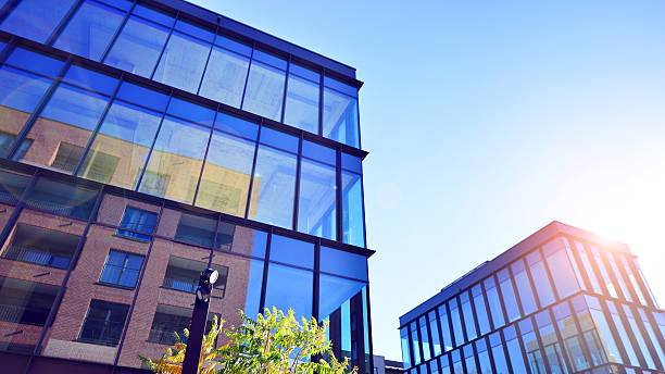 istock Exterior of modern building with many windows against blue sky, low angle view. 2250460374