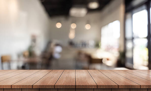 istock Empty wooden table top with lights bokeh on blur restaurant background. 2250460599