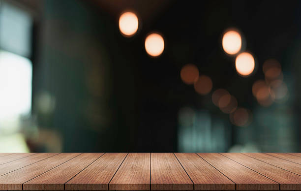 istock Empty wooden table top with lights bokeh on blur restaurant background. 2250460640