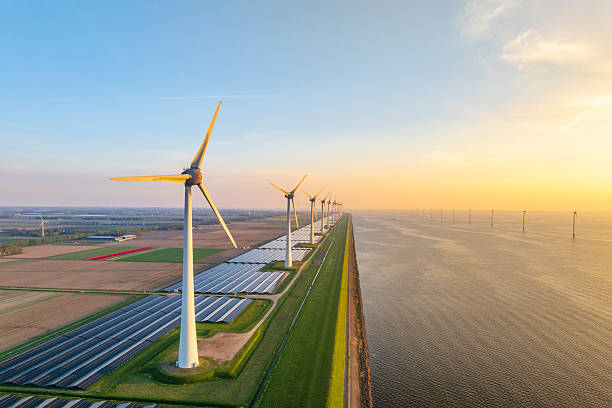 istock Wind turbines and solar panels on a lakeshore 2250462896