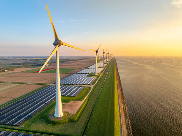 istock Wind turbines and solar panels on a lakeshore 2250463046