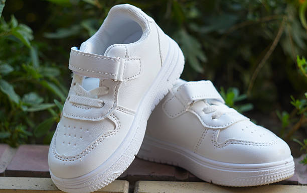 istock White sneakers on the ground in nature 2250463617