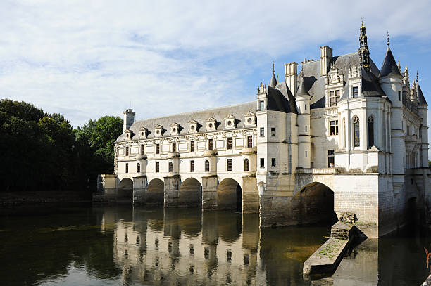 Chenonceaux, France - August 7, 2013: Historic Chateau de Chenonceau with river view under sunny summer sky showing cultural landmark