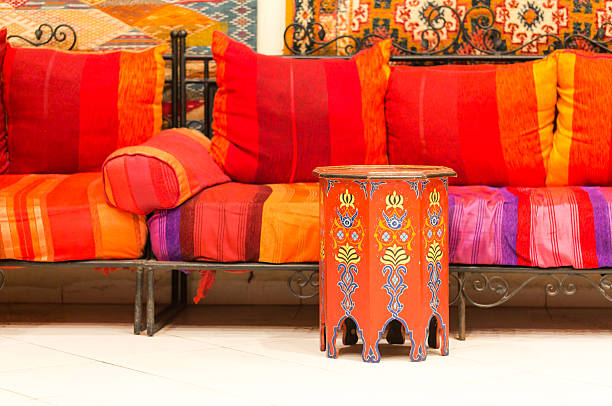 istock Colourful Moroccan sofa lounge with bright cushions and hand-painted ornate side table decor home interior 2250469548