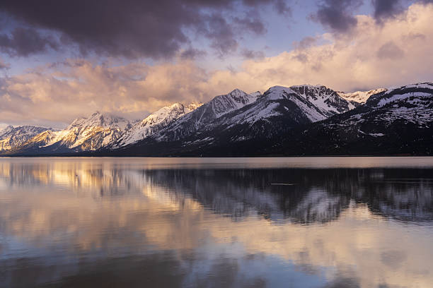 istock A tranquil morning on Jackson Lake, with mountains and clouds reflected on the still surface of the lake. 2250469928