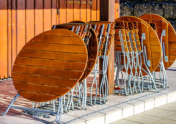 wooden benches and tables at a typical bavarian beergarden - photo