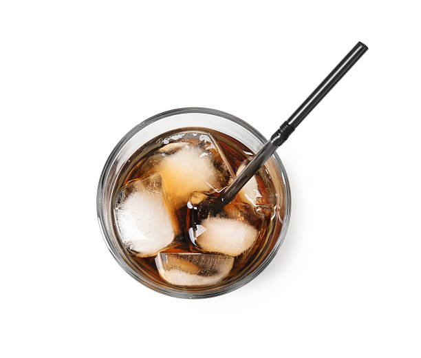 istock Refreshing cola with ice cubes and drinking straw in glass isolated on white, top view 2250470672