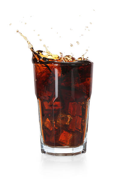 istock Refreshing cola with ice cubes splashing in glass isolated on white 2250470721