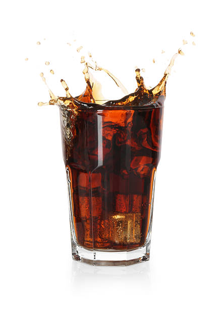istock Refreshing cola with ice cubes splashing in glass isolated on white 2250470723