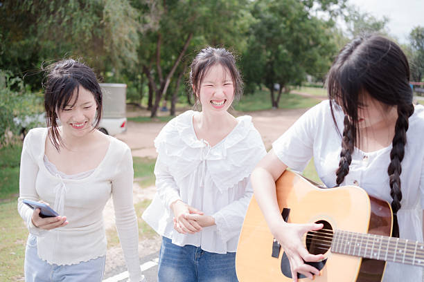 Portrait of Asian family duo band with two guitarist of father and daughter on white background for music, artist, musician style
