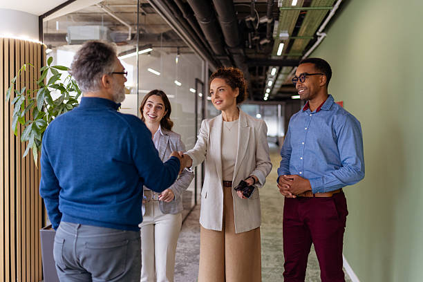 istock Diverse Business Team Celebrating Success with Handshake in Modern Office 2250472489