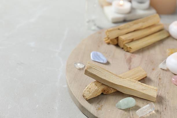 istock Palo santo sticks and gemstones on light table. Space for text 2250473681