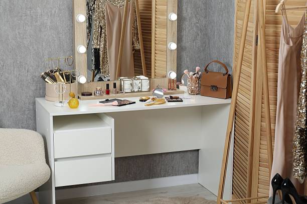 istock Makeup room. Mirror, dressing table, different beauty products and clothing rack indoors 2250475372
