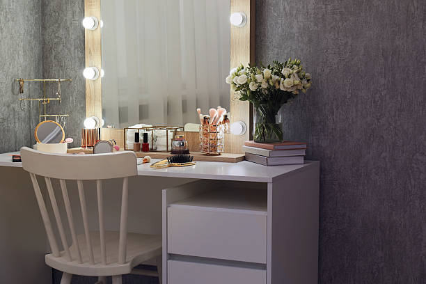 istock Makeup room. Mirror, dressing table, different beauty products and chair indoors 2250475451