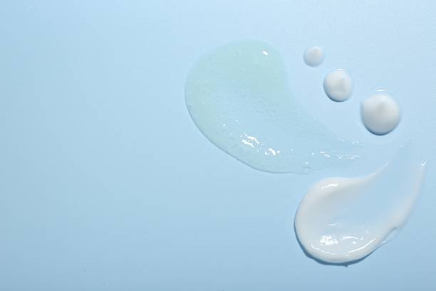 istock Cream and gel samples on light blue background, top view. Space for text 2250476757