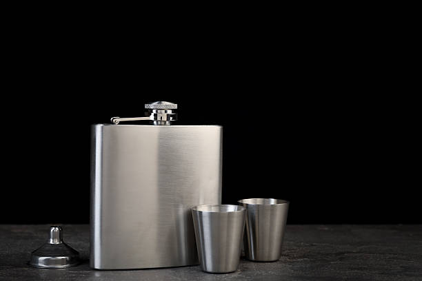 istock Hip flask, cups and funnel on grey table, space for text 2250478413