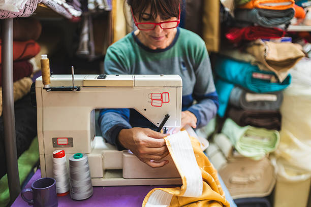 istock Small Business Owner Sewing Curtains on Machine for Clients 2250481896