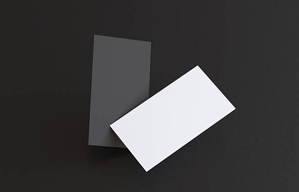 istock Flying business cards on black background 2250482939