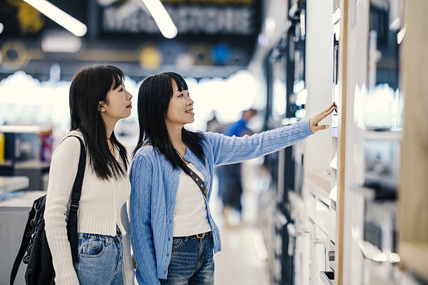 istock Two women shopping for modern home appliances in electronics store 2250483083