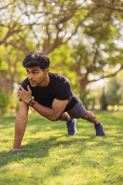istock Determined man performs push-up in sunny park during outdoor fitness training session 2250483195