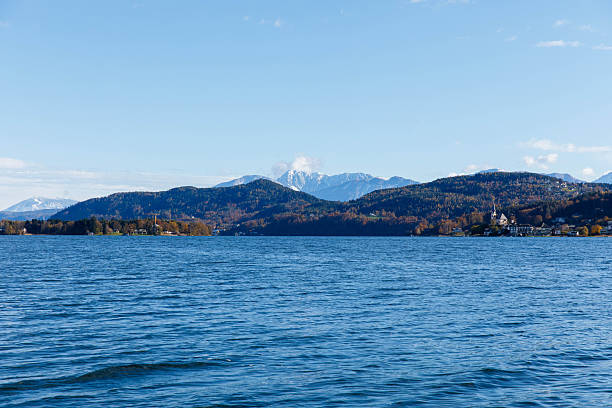 istock Idyllic alpine lake scene with mountain range and clear blue sky 2250486459