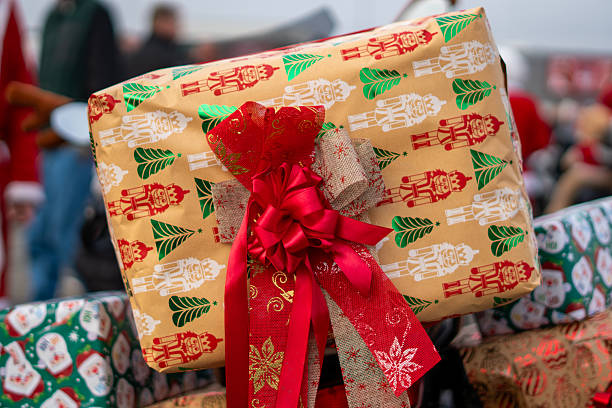 Christmas gift wrapped in nutcracker patterned paper with a ribbon displayed as decoration during a festive holiday motorcycle parade