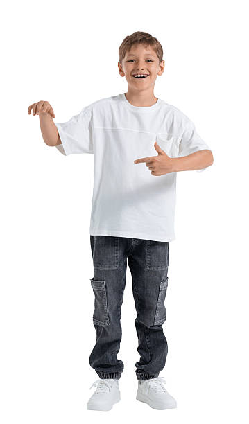 istock Smiling boy in casual outfit pointing with hands while standing 2250493820