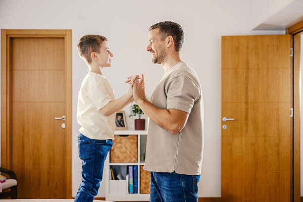 istock Father and son playing patty cake bonding at home 2250493947