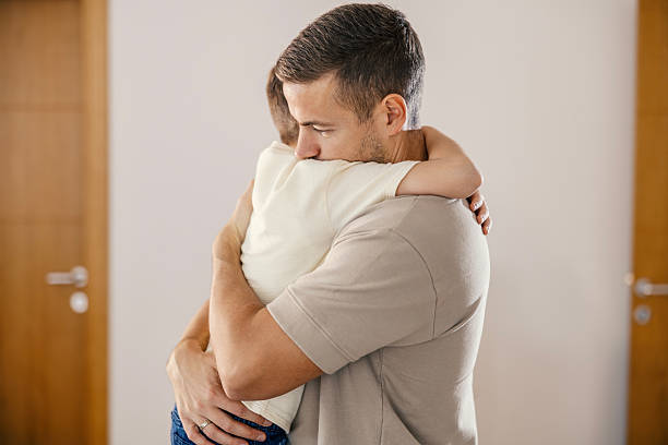istock Father hugging child demonstrating love and comfort 2250493949