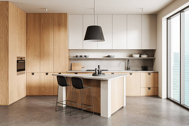 istock Modern minimalist kitchen interior with wood and white cabinetry, concrete surfaces, and large window in contemporary apartment concept design. 3D Rendering 2250493976