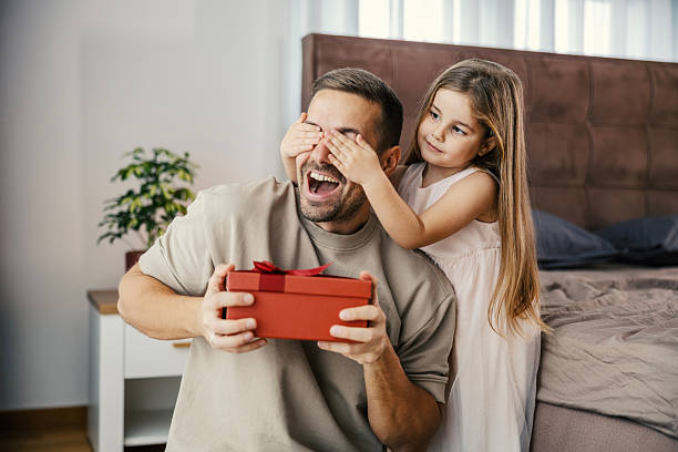 istock Daughter surprising father with present on father's day 2250494194