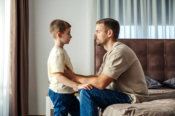 istock Father and son having serious conversation in bedroom 2250494273