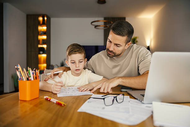istock Father helping boy with math homework at home 2250494466