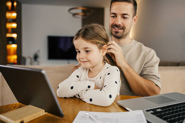 istock Father and daughter learning together at home 2250494655